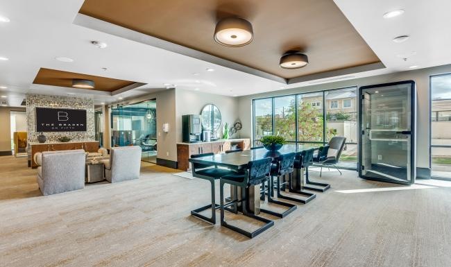 a large common room with a table and chairs