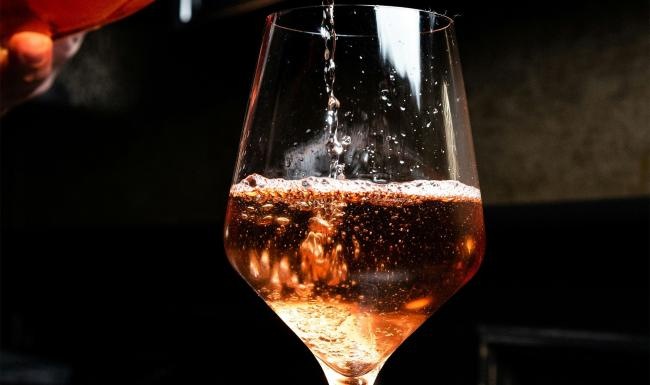 a glass of wine being poured