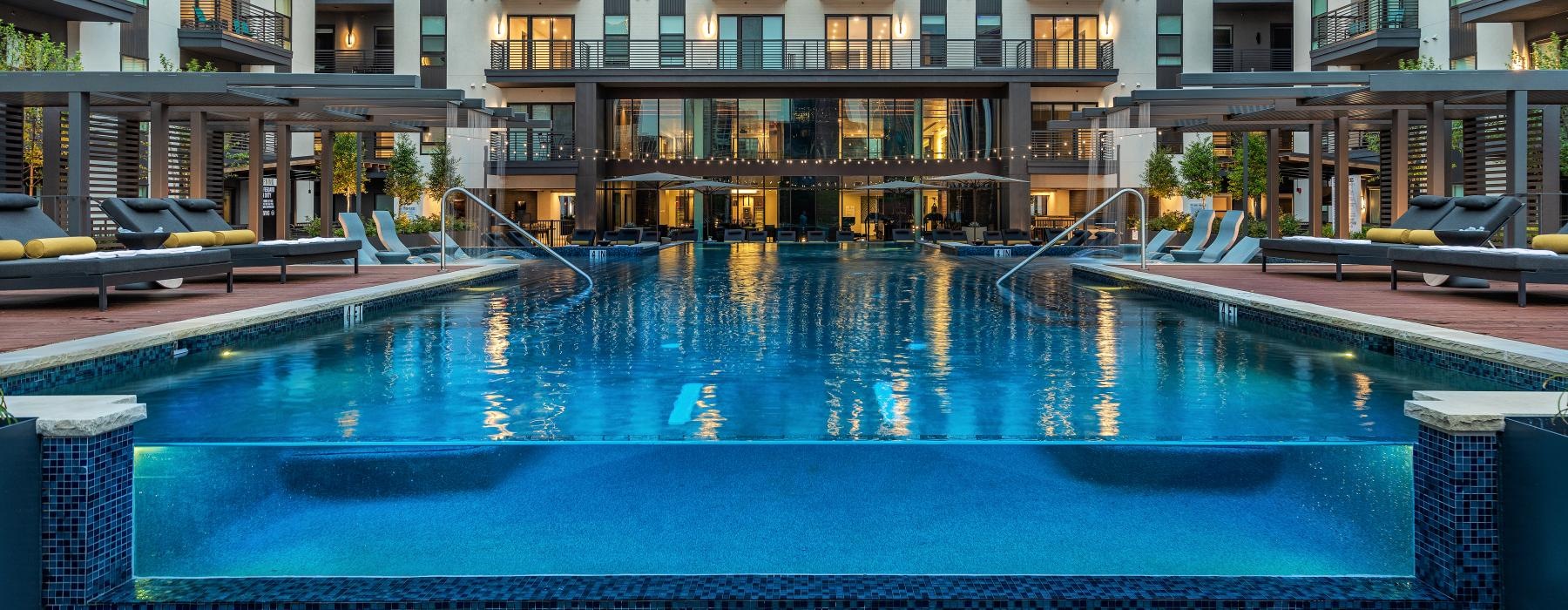a pool in a courtyard with buildings around it