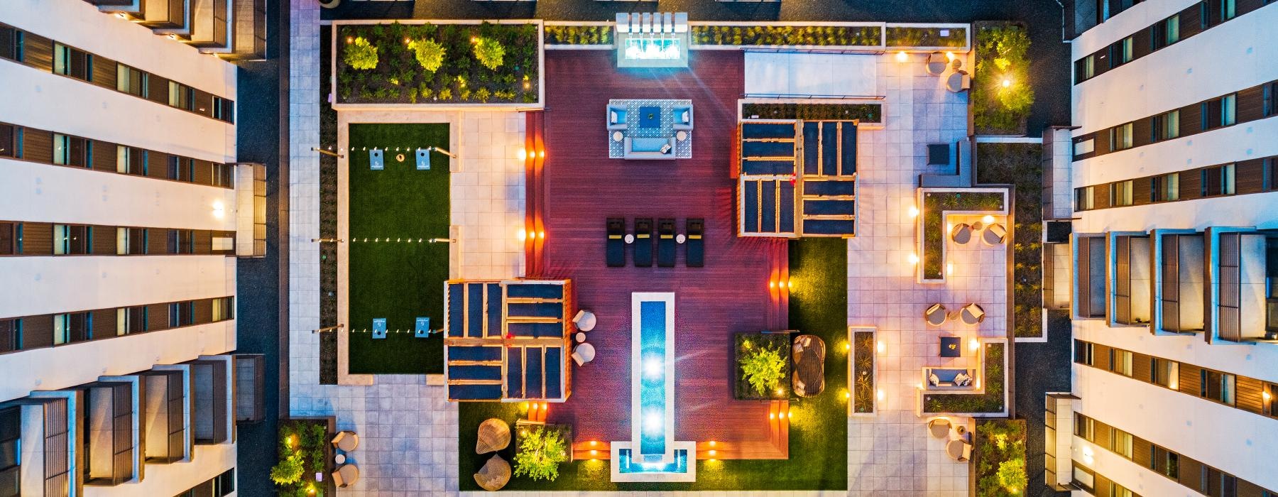 a building with a pool and chairs